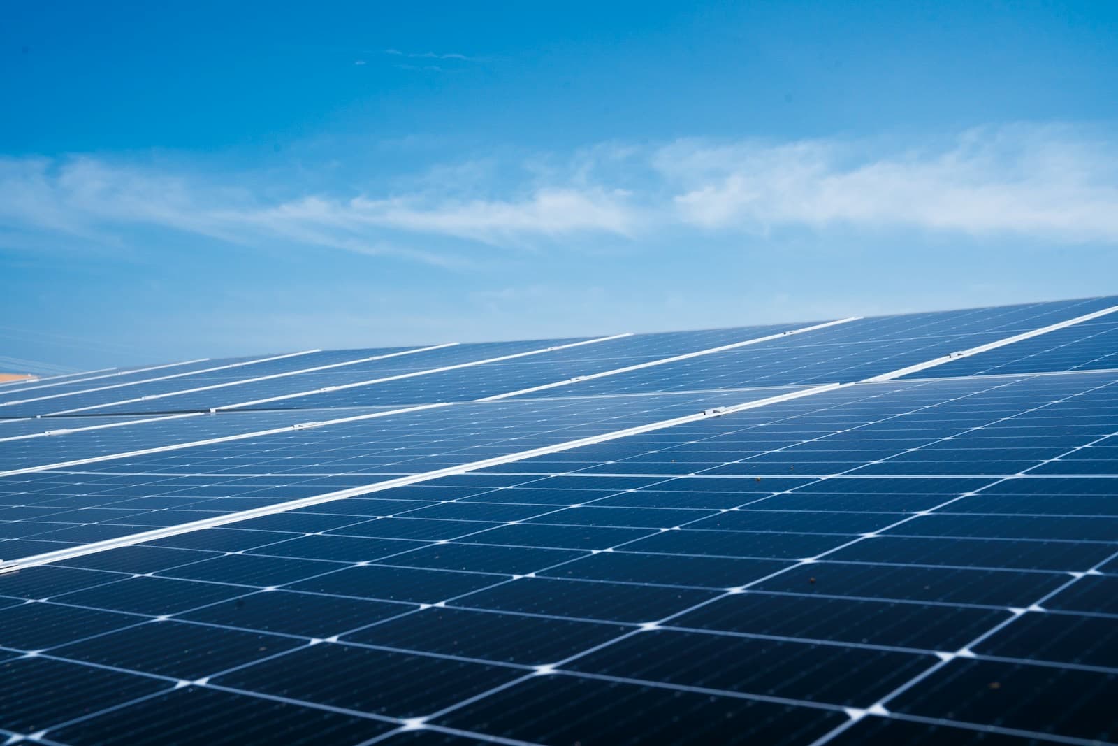 Rows of solar panels under a clear blue sky
